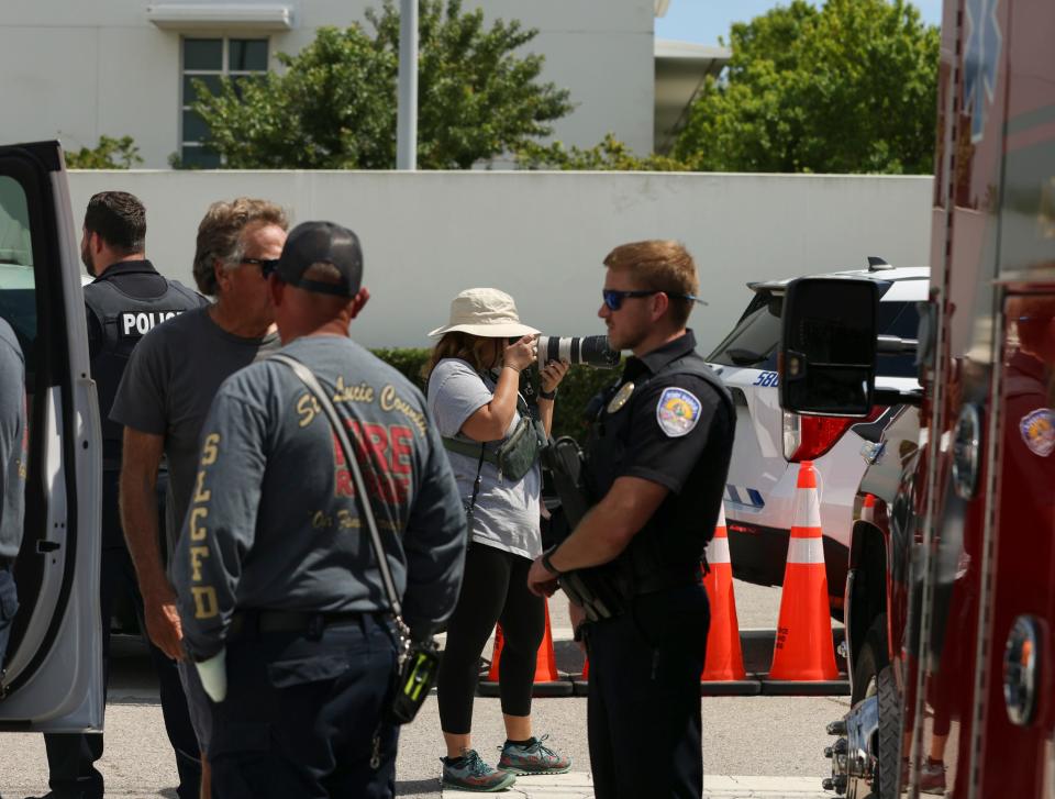 Staff visual journalist Kaila Jones (center) documents activities outside the Alto Lee Adams Sr. U.S. Courthouse during Trump's classified documents hearing Thursday, March 14, 2024, in Fort Pierce.