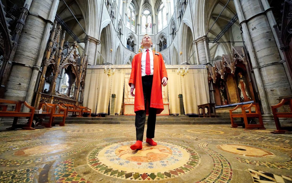 Abbey Marshal Howard Berry walks across the centre of the Cosmati pavement - Jonathan Brady/PA