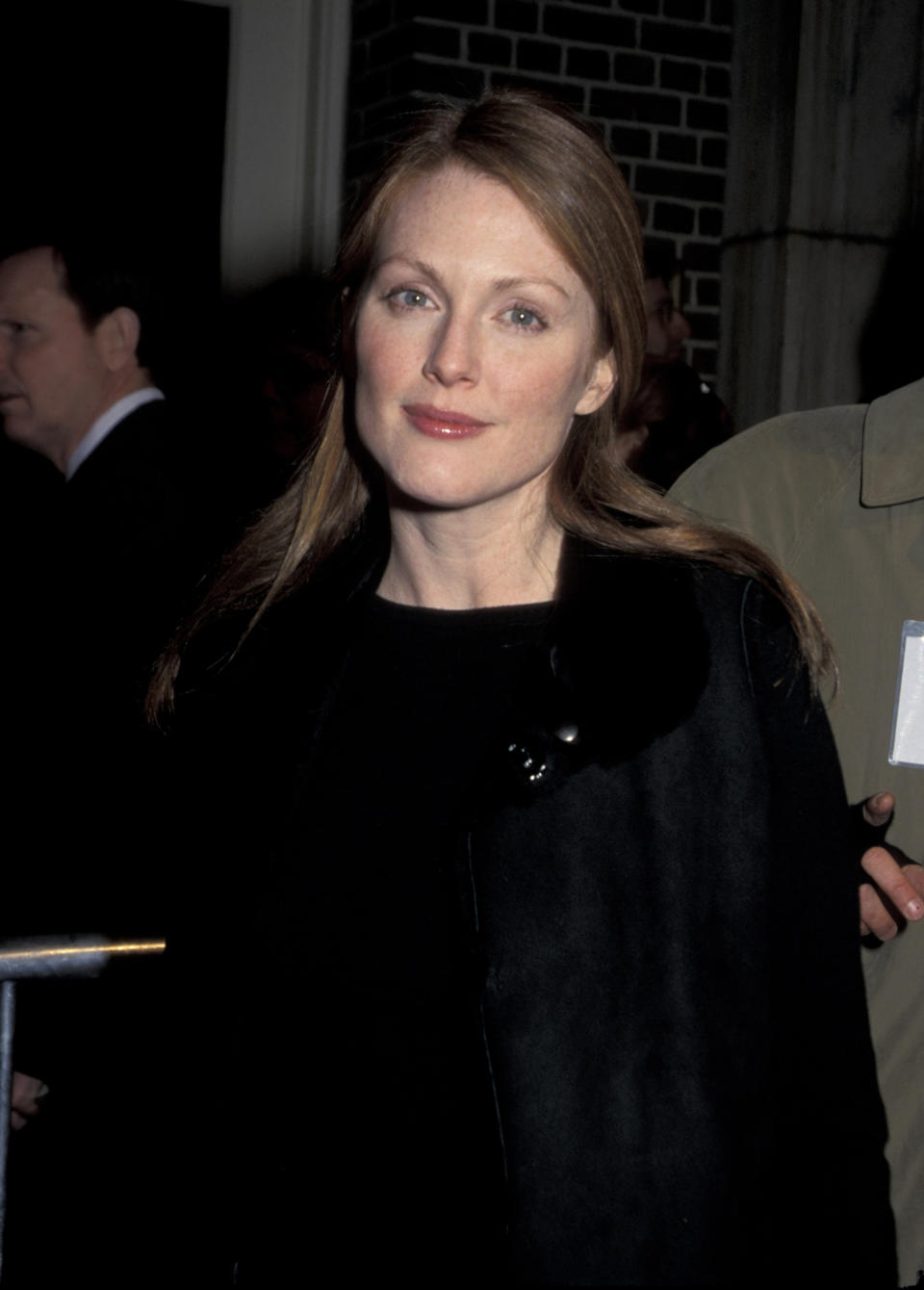 Julianne Moore at an event wearing a black coat with a brooch