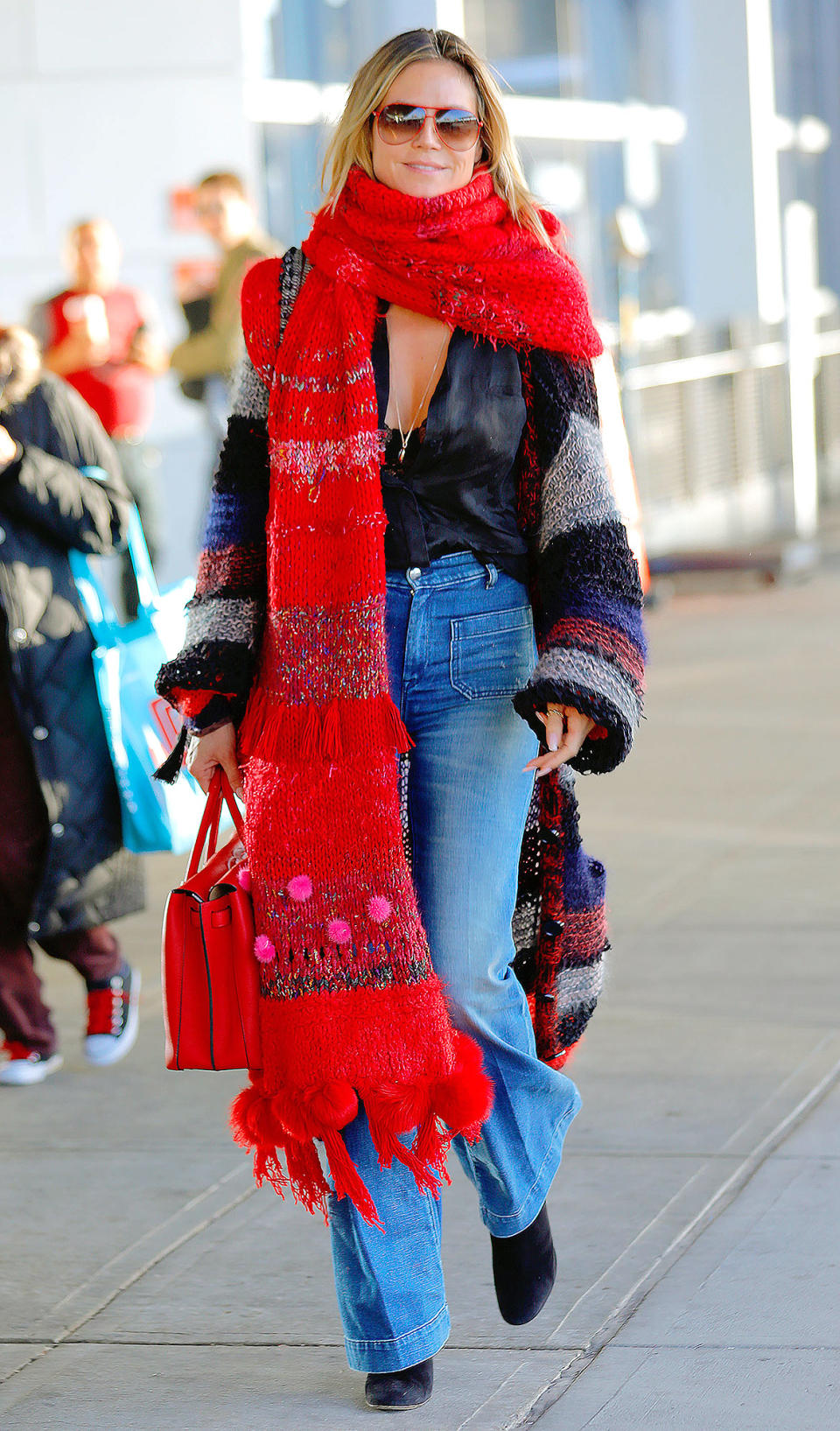 <p>Heidi Klum may not be an “American Woman,” but clearly she's feeling some <a rel="nofollow noopener" href="http://people.com/style/its-a-thanksgiving-throwbackthursday-and-were-thankful-for-lenny-kravitzs-scarf-blanket-hybrid/" target="_blank" data-ylk="slk:festive Lenny Kravitz vibes;elm:context_link;itc:0;sec:content-canvas" class="link ">festive Lenny Kravitz vibes</a> in this outfit-obscuring scarf adorned with pom-poms and fringe for an extra dose of holiday spirit. </p>