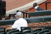 Baltimore Orioles manager Brandon Hyde, right, wears a face mask to protect against the coronavirus as he talks with general manager Mike Elias during baseball training camp, Friday, July 3, 2020, in Baltimore. (AP Photo/Julio Cortez)