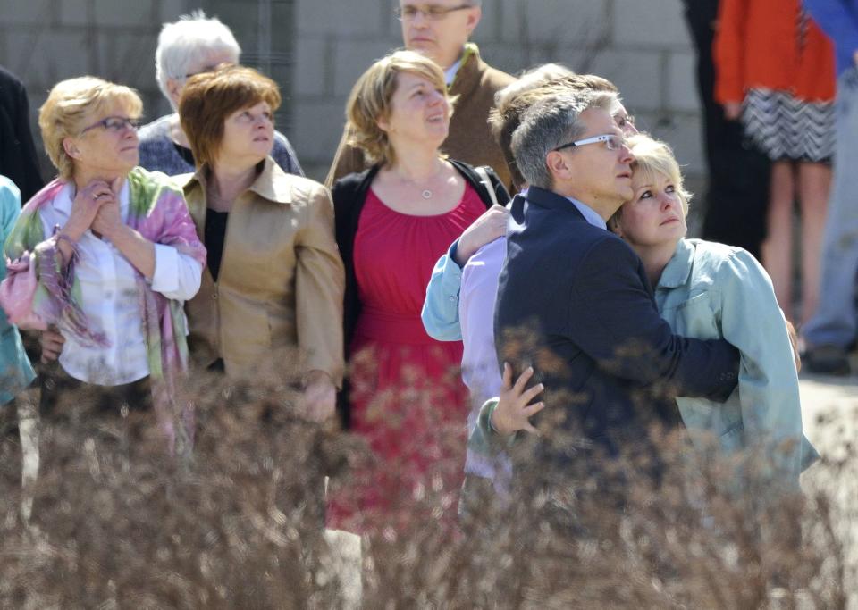 Family and friends of Kaiti Perras watch as balloons are released after her funeral at the First Alliance Church in Calgary, Alberta, April 21, 2014. Matthew de Grood has been charged with killing Perras and four of her friends at a house party in Calgary's worst mass murder in the history of the city, according to local media reports. REUTERS/Mike Sturk (CANADA - Tags: CRIME LAW OBITUARY)