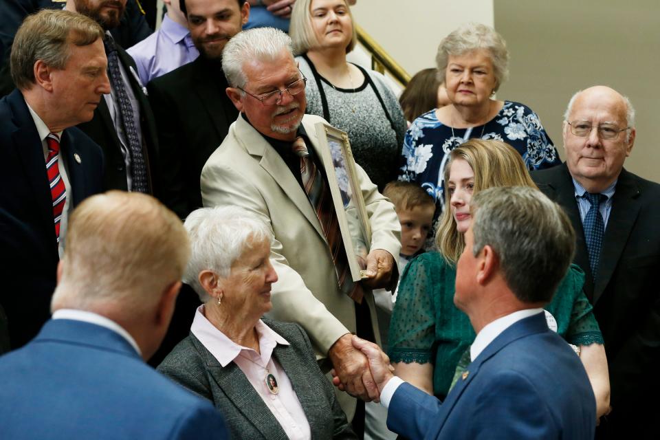 Georgia Gov. Brian Kemp shakes hands with Milton Coleman, father of Rhonda Sue Coleman, before signing HB 88, the Coleman-Baker Act, at the Athens-Clarke County Courthouse in downtown Athens, Ga., on Friday, April 28, 2023. Rhonda Sue Coleman, 18, was slain May 17, 1990, in Hazelhurst. Her case remains unsolved.