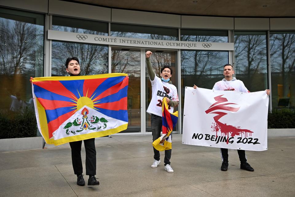 Activists of the International Tibet Network holds Tibet's flags in front of the IOC headquarters during a protest against Beijing 2022 Winter Olympics on February 3, 2021 in Lausanne. A coalition of campaign groups issued an open letter calling on world leaders to boycott the Beijing 2022 Winter Olympics over China's rights record.AFP via Getty Images