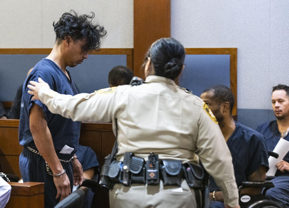 Yoni Barrios is led out of the courtroom after his appearance for a status check on the filing of a criminal complaint at the Regional Justice Center, on Tuesday, Oct. 11, 2022, in Las Vegas. Barrios is a suspect in a stabbing rampage on the Las Vegas Strip that left two people dead and six injured. (Bizuayehu Tesfaye /Las Vegas Review-Journal via AP)