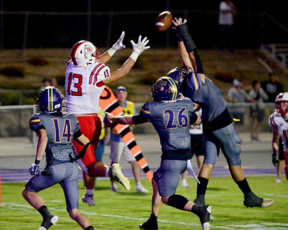 Ripons Owen Wilbur (13) tries to make a catch between multiple Escalon defenders during a game between Escalon High School and Ripon High School in Escalon, California on October 20, 2023. 