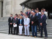 About two dozen House Republican lawmakers stand on the Louisiana Capitol steps in support of a petition that would end the state of emergency over COVID-19, on Wednesday, June 25, 2020, in Baton Rouge, La. The lawmakers have restarted a petition effort that failed to gain enough signatures earlier in the year, hoping to end the state of emergency declared by Democratic Gov. John Bel Edwards. (AP Photo/Melinda Deslatte)