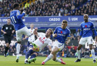 Tottenham's Harry Kane, center, duels for the ball with Everton's Demarai Gray, left, and Everton's Lucas Digne during the English Premier League soccer match between Everton and Tottenham Hotspur at Goodison Park in Liverpool, England, Sunday, Nov. 7, 2021. (AP Photo/Jon Super)
