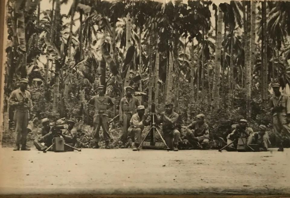 Thomas Bostick served in the Philippines as part of the 93rd Infantry Division, where he was one of two all-Black divisions that saw combat. In this photo, Bostick is one of the two men operating the artillery on the left.