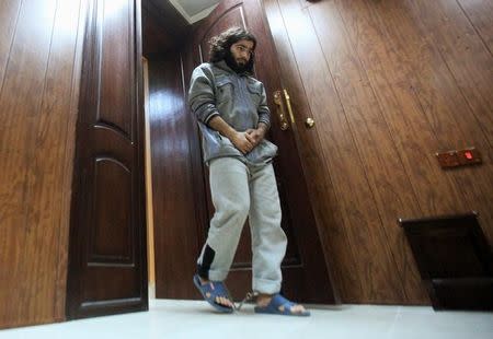 Former bakery worker Walid Ismail walks with his ankles shackled during an interview with Reuters in a Kurdish security compound in the city of Erbil, Iraq November 28, 2016. Picture taken November 28, 2016. REUTERS/Azad Lashkari