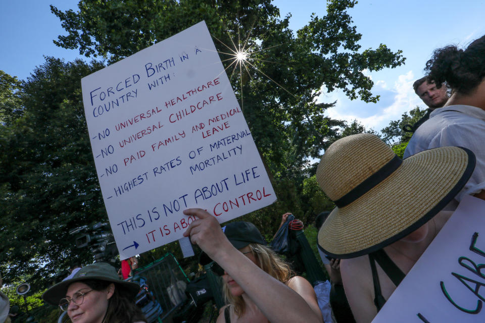 Someone holding a sign that says, "Forced birth in a country with -no universal healthcare -no universal childcare -no paid family or medical leave -highest rates of maternal mortality. This is not about life. It is about control."