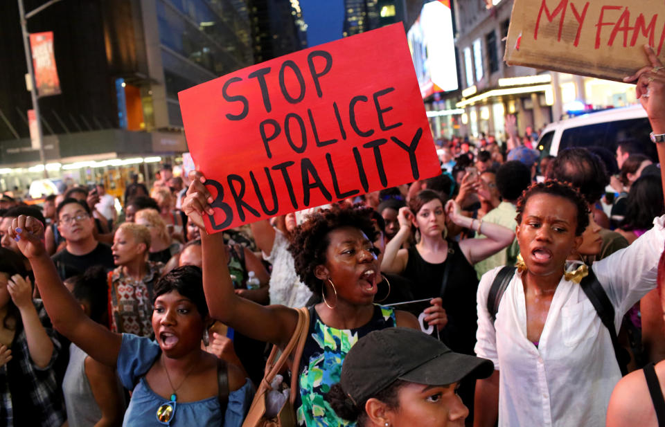 Activists protest in Times Square in response to the recent fatal shootings of black men by police.