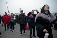 Tourists take photos of the daily flag raising ceremony at Tiananmen Square on the eve of the opening session of China's National People's Congress (NPC) in Beijing, Tuesday, March 5, 2019. A year since removing any legal barrier to remaining China's leader for life, Xi Jinping appears firmly in charge, despite a slowing economy, an ongoing trade war with the U.S. and rumbles of discontent over his concentration of power. (AP Photo/Mark Schiefelbein)