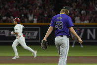 Colorado Rockies relief pitcher Jake Bird pauses on the pitcher's mound after giving up a three-run home run to Arizona Diamondbacks' Alek Thomas, left, during the sixth inning of a baseball game Friday, March 29, 2024, in Phoenix. (AP Photo/Ross D. Franklin)