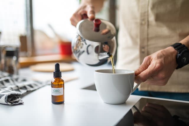 <p>miodrag ignjatovic / Getty Images</p> Male added CBD oil into his morning tea to use it as a medicine.