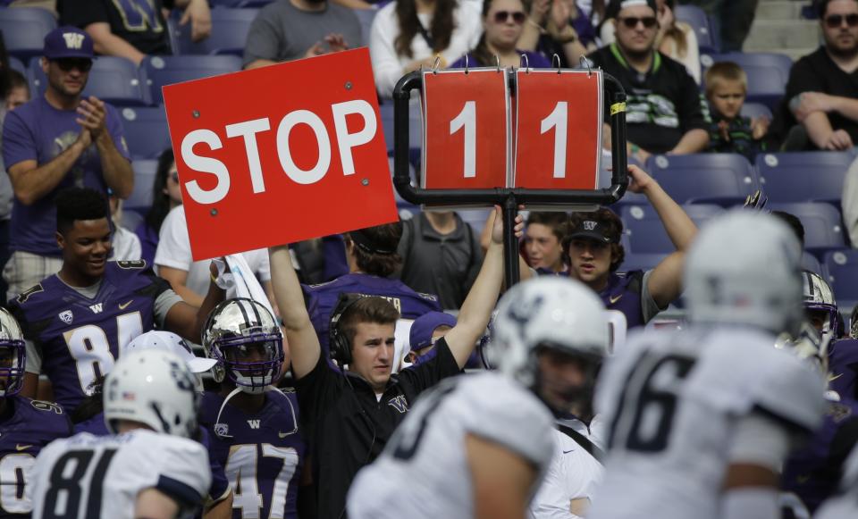 FILE - A play is signaled from the Washington sideline in the second half of an NCAA college football game against Utah State in Seattle, Sept. 19, 2015. (AP Photo/Ted S. Warren, File)