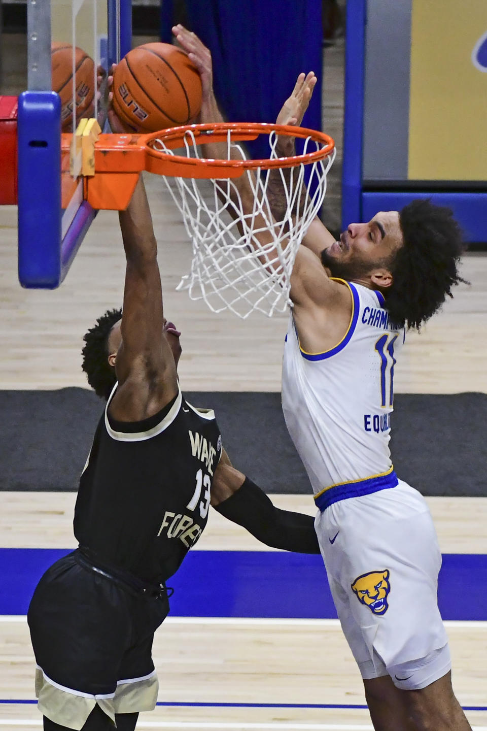 Pittsburgh forward Justin Champagnie blocks the shot of Wake Forest guard Quadry Adams during the second half of an NCAA college basketball game, Tuesday, March 2, 2021, in Pittsburgh. (AP Photo/Fred Vuich)