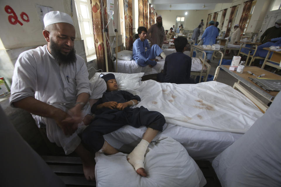 Injured people lie on the bed at a hospital after Sunday's suicide bomber attack, in the Bajur district of Khyber Pakhtunkhwa, Pakistan, Monday, July 31, 2023. Pakistan held funerals on Monday for victims of a massive suicide bombing that targeted a rally of a pro-Taliban cleric the previous day. (AP Photo/Mohammad Sajjad)