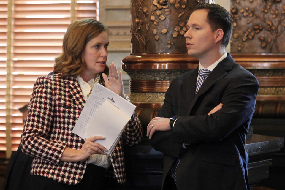 Kansas Senate Minority Leader Dinah Sykes, D-Lenexa, confers with Sen. Chase Blasi, R-Wichita, during the Senate's debate over a $19 billion spending bill funding most state agencies and services for another year, Friday, April 5, 2024, at the Statehouse in Topeka, Kan. The bill drew criticism for not stopping a 93% pay increase for legislators set to take effect in 2025. (AP Photo/John Hanna)