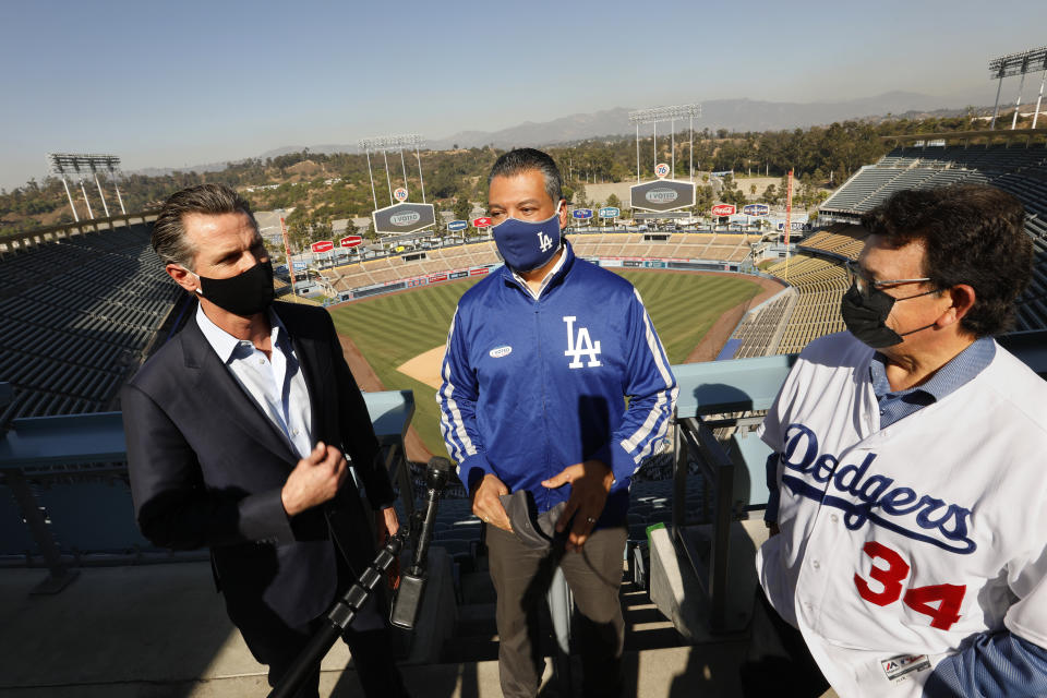 California Secretary of State Alex Padilla (center) celebrates the L.A. Dodgers' World Series win with Newsom (left). Padilla is widely viewed as a front-runner to replace Sen. Harris. (Photo: Carolyn Cole/Getty Images)