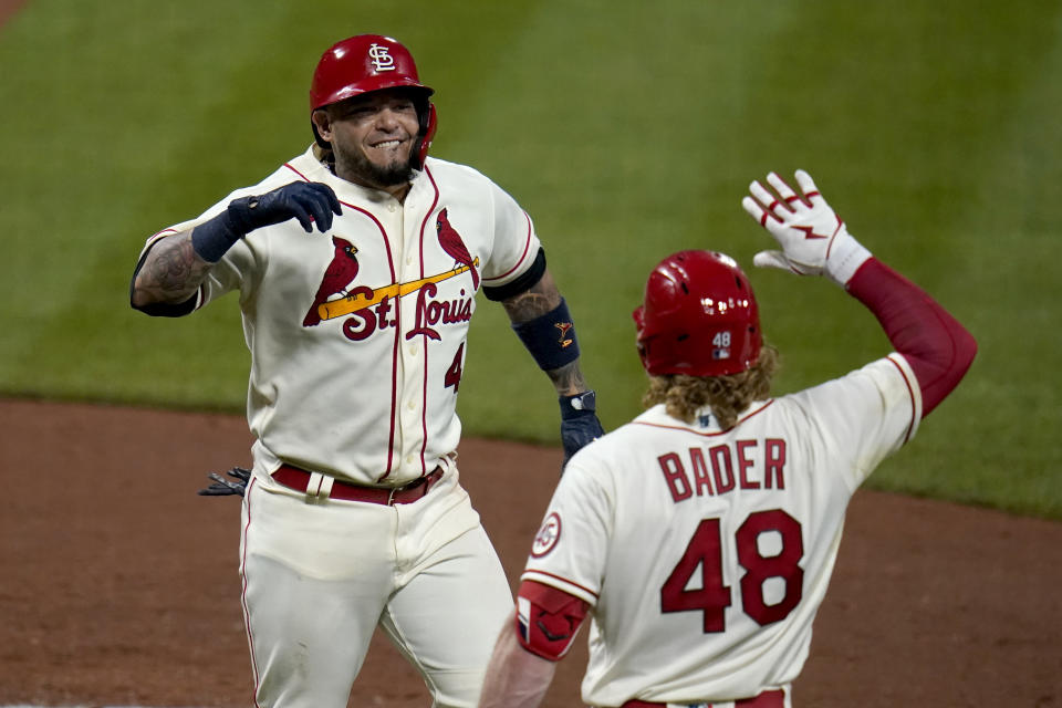 St. Louis Cardinals' Yadier Molina, left, is congratulated by teammate Harrison Bader (48) after hitting a solo home run during the seventh inning of a baseball game against the Chicago Cubs Saturday, May 22, 2021, in St. Louis. (AP Photo/Jeff Roberson)