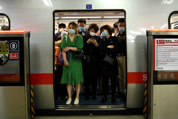 Passengers wearing face masks commute on a subway train during rush hour in Beijing.