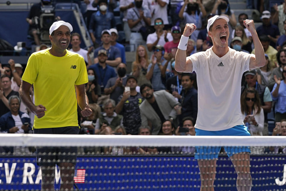 Joe Salisbury, of Great Britain, right, and teammate Rajeev Ram, of the United States, celebrate their men's doubles final victory over Bruno Soares, of Brazil, and Jamie Murray, of Great Britain, at the US Open tennis championships, Friday, Sept. 10, 2021, in New York. (AP Photo/Elise Amendola)