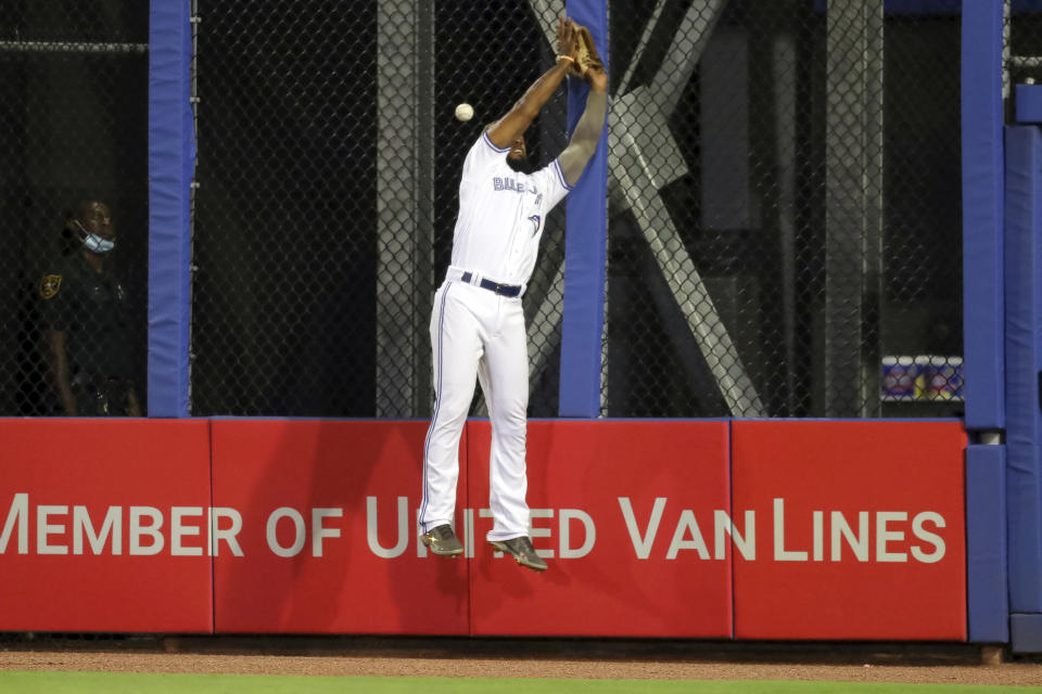 Toronto Blue Jays right fielder Teoscar Hernandez cannot catch a fly ball by Philadelphia Phillies' Alec Bohm ,allowing a run to score, during the seventh inning of a baseball game Friday, May 14, 2021, in Dunedin, Fla. (AP Photo/Mike Carlson)