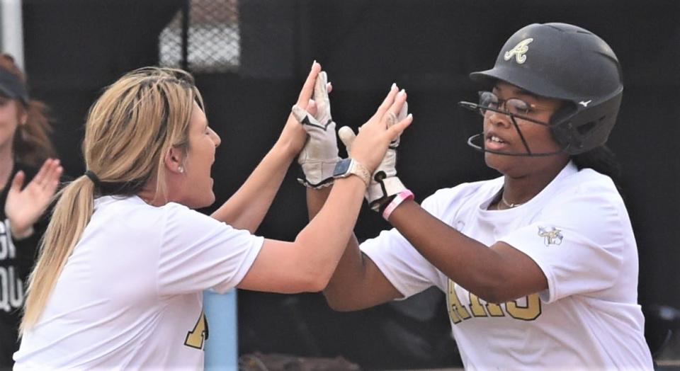 Abilene High coach Jenna Bane celebrates with Amyah Starks as Starks rounds third base after hitting a two-run homer in the third inning against Cooper. AHS won the District 4-5A game 9-5 on April 4 at Abilene High.