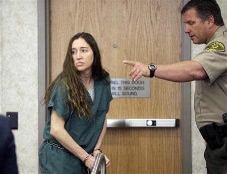 Megan Huntsman, accused of killing six of her babies and storing their bodies in her garage, appears in court in Provo, Utah, April 28, 2014. REUTERS/Rick Bowmer/Pool