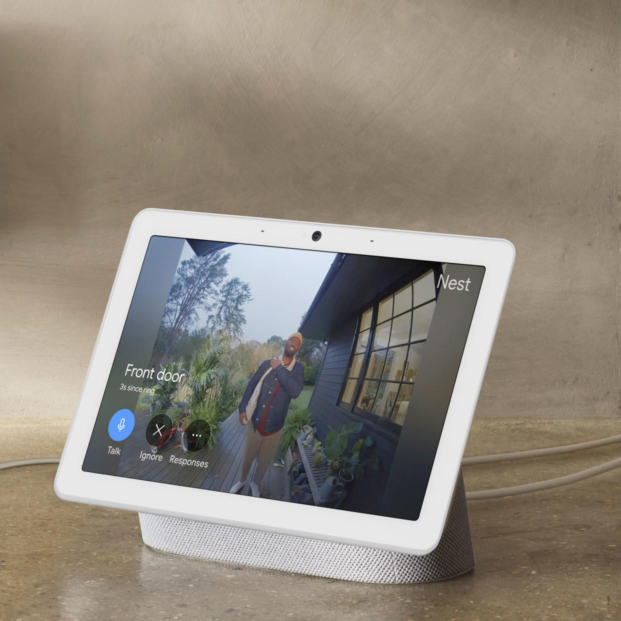  A Google smart hub speaker showing the view from the front door via a video doorbell for smart home security. 