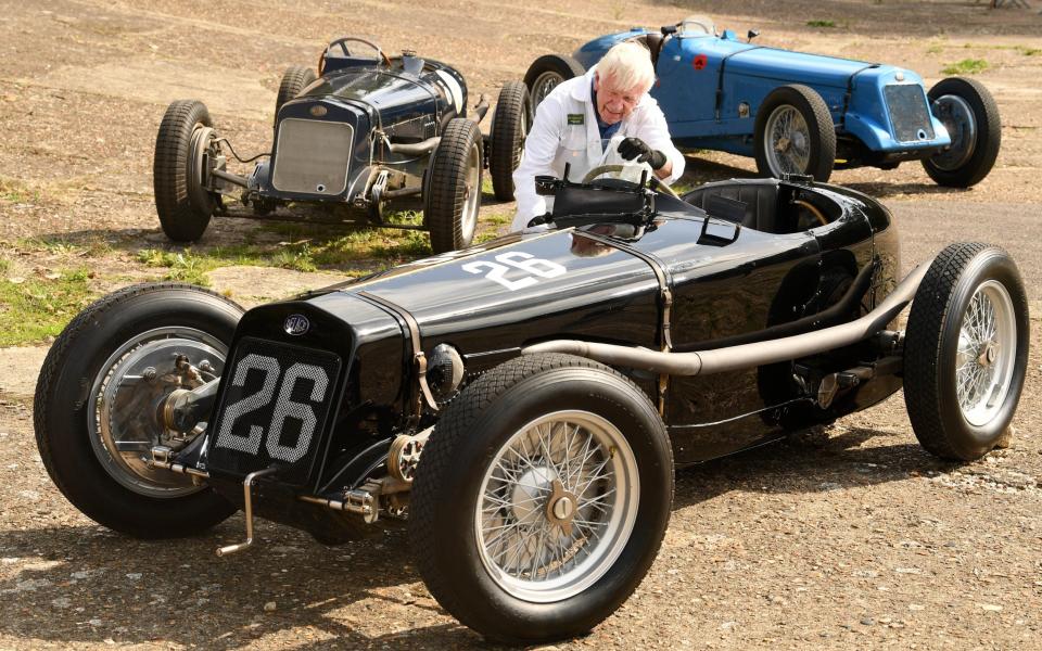 Volunteer Garry Matthews cleans the drivers window of the winning car, one of only six manufactured by designer Louis Delage - Russell Sach