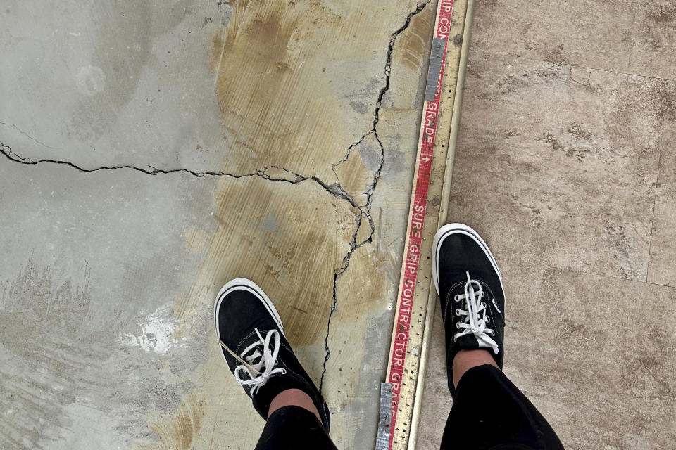 Cracks run along the floor in an apartment rented by Shauna Dixon before a section of the 116-year-old Davenport apartment building later collapsed in May. The collapse left three dead, and about 50 homeless without their possessions. (Shauna Dixon via AP)