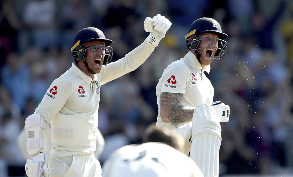 England's Jack Leach and Ben Stokes, right, celebrate victory on day four of the third Ashes cricket Test match against Australia at Headingley, Leeds, England, Sunday Aug. 25, 2019. (Mike Egerton/PA via AP)