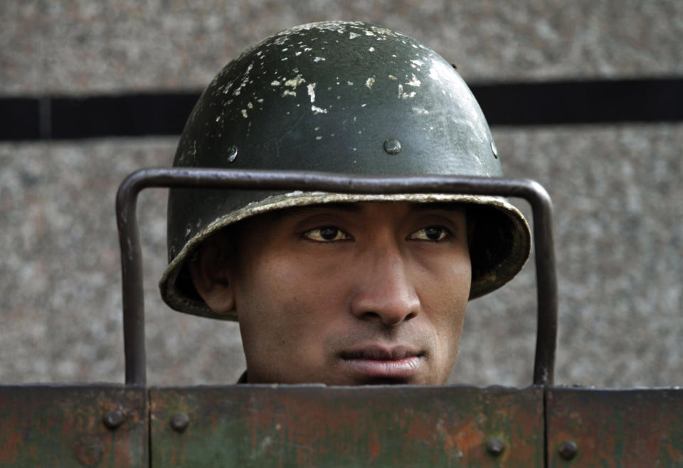 FILE- An Indian paramilitary soldier stands guard during curfew in Srinagar, Indian controlled Kashmir, Sept. 15, 2010. For decades, India has tried to thwart Pakistan in a protracted dispute over Kashmir. But in the last two years, policy makers in New Delhi have been increasingly turning their focus to Beijing, in a significant shift in India's foreign policy as the nation celebrates 75 years of independence. (AP Photo/Dar Yasin, File)