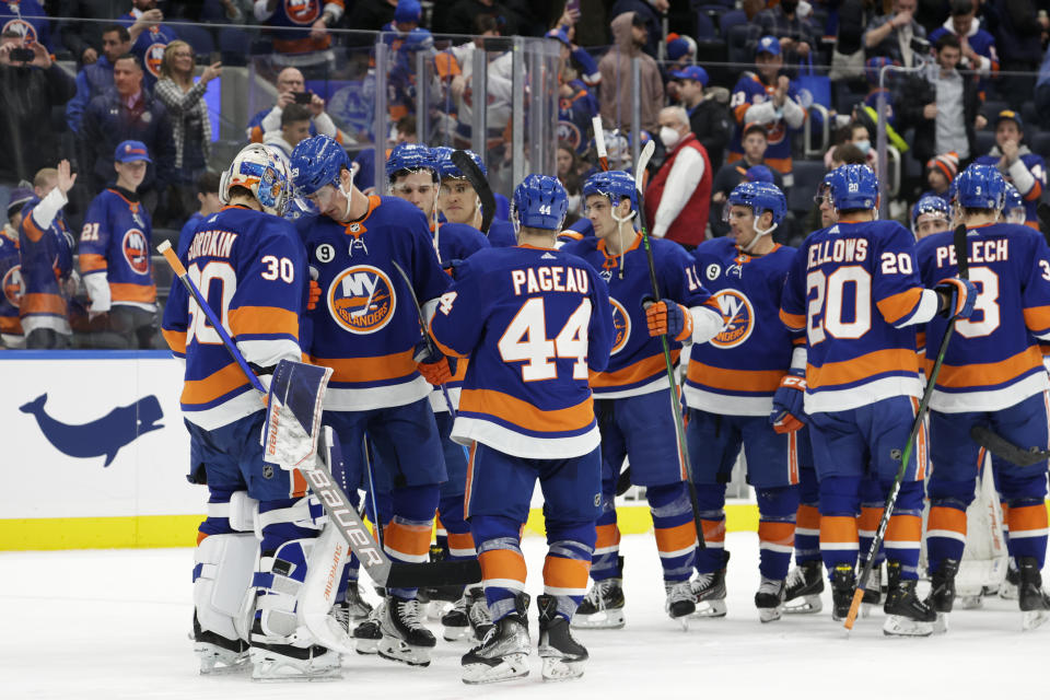 The New York Islanders celebrate their win with goaltender Ilya Sorokin (30) after an NHL hockey game against the Philadelphia Flyers, Tuesday, Jan. 25, 2022, in Elmont, N.Y. (AP Photo/Corey Sipkin).