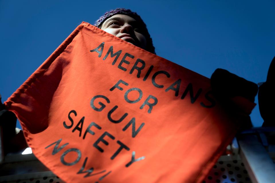 In this March 24, 2018, file photo, Isabel White of Parkland, Fla., holds a sign that reads "Americans for Gun Safety Now!" during the "March for Our Lives" rally in support of gun control in Washington, that was spearheaded by teens from Marjory Stoneman Douglas High School after the 2018 mass shooting in Parkland, Fla. President Biden faces an uphill battle as he tries to push for more state laws that would allow authorities to temporarily disarm people who are considered a danger to themselves or others.