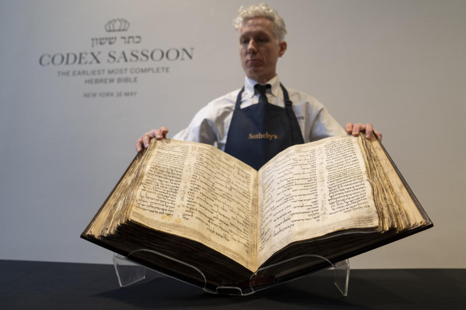 FILE - Sotheby's unveils the Codex Sassoon for auction, Wednesday, Feb. 15, 2023, in the Manhattan borough of New York. The 1,100-year-old Hebrew Bible that is one of the oldest surviving biblical manuscripts sold for $38.1 million, which includes the auction house's fee, Wednesday, May 17, 2023, in New York. (AP Photo/John Minchillo, File)