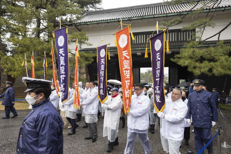 Well-wishers arrive at the Imperial Palace in Tokyo to greet Japanese Emperor Naruhito on his birthday Friday, Feb. 23, 2024. (Stanislav Kogiku/Pool Photo via AP)