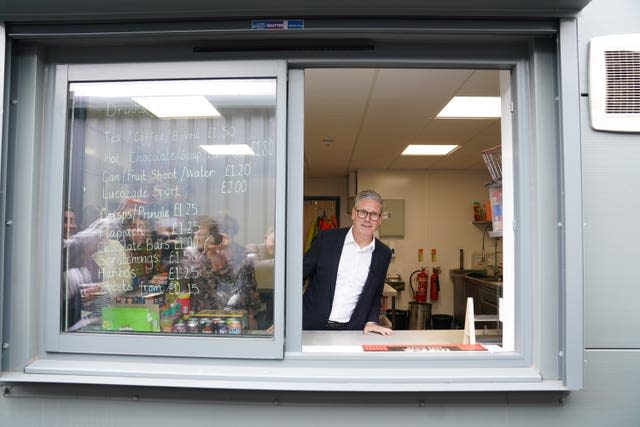 Sir Keir Starmer standing behind the counter of a snack bar
