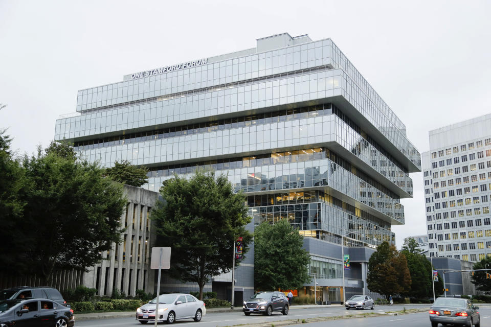 FILE - In this Sept. 12, 2019, file photo, cars pass Purdue Pharma headquarters in Stamford, Conn. The Sackler name is on a wing of the Metropolitan Museum of Art and used to be on one at the Louvre. But now the Sackler family wealth has become linked to sales of OxyContin, and their company, drug maker Purdue Pharma, is attempting to settle lawsuits over the opioid crisis. (AP Photo/Frank Franklin II, File)