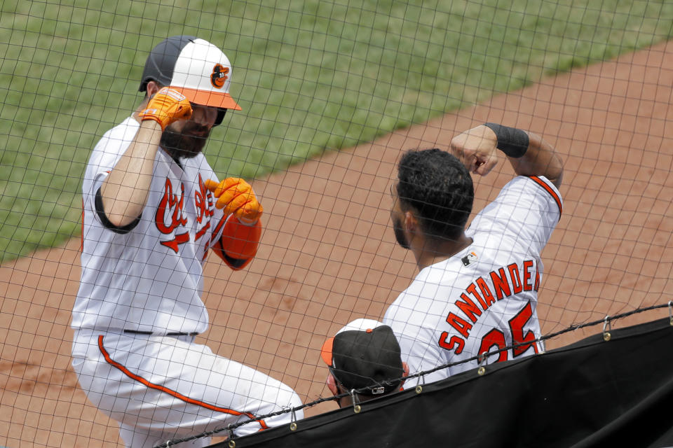 Baltimore Orioles' Renato Nunez, left, is greeted near the dugout by Anthony Santander after hitting a solo home run off Tampa Bay Rays relief pitcher Yonny Chirinos during the third inning of a baseball game, Sun, Aug. 2, 2020, in Baltimore. (AP Photo/Julio Cortez)