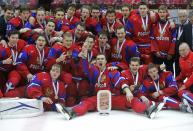 Russia's Nikita Tryamkin (C) and his teammates celebrate after defeating Canada to win the bronze medal after their IIHF World Junior Championship ice hockey game in Malmo, Sweden, January 5, 2014. REUTERS/Alexander Demianchuk (SWEDEN - Tags: SPORT ICE HOCKEY)