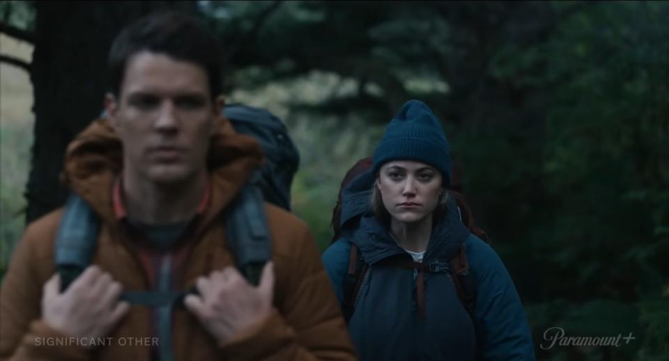 Still from Significant Other movie. Man and woman hike through the woods