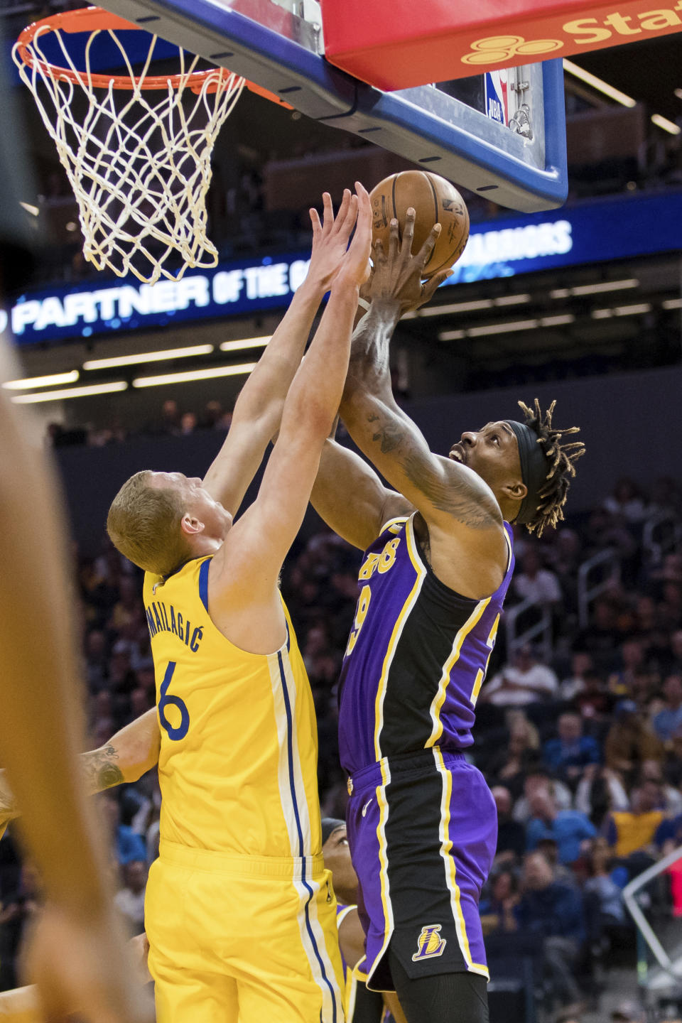 Los Angeles Lakers center Dwight Howard, left shoots as Golden State Warriors forward Alen Smailagic (6) defends in the first half of an NBA basketball game in San Francisco Saturday, Feb. 8, 2020. (AP Photo/John Hefti)