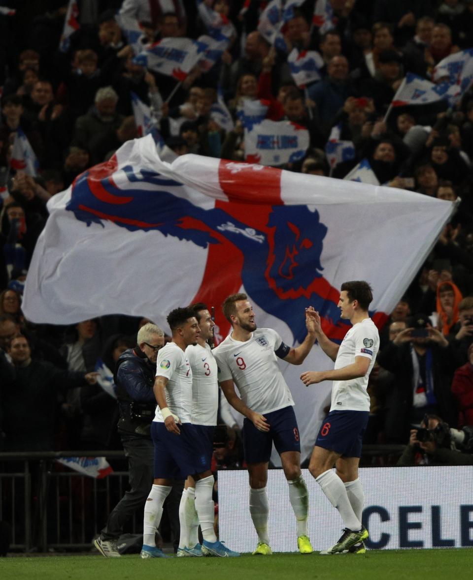 England's Harry Kane, center, celebrates with his teammates after scoring his side's third goal during the Euro 2020 group A qualifying soccer match between England and Montenegro at Wembley stadium in London, Thursday, Nov. 14, 2019. (AP Photo/Ian Walton)