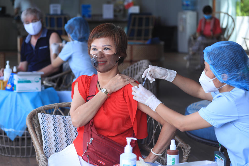 A woman receives a shot of the Moderna COVID-19 vaccine in Vung Tau, Vietnam, Monday, Sep. 13, 2021. Vietnam is speeding up its vaccination program in an effort to loosen coronavirus lockdown restrictions in major cities by the end of September, the government said. (AP Photo/Hau Dinh)