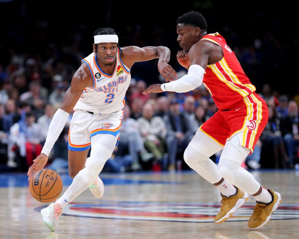 Oklahoma City's Shai Gilgeous-Alexander (2) looks to get around Atlanta's Aaron Holiday (3) in the second half during the NBA basketball game between the Oklahoma City Thunder and the Atlanta Hawks at the Paycom Center  in Oklahoma City, Wednesday, Jan.25, 2023. 