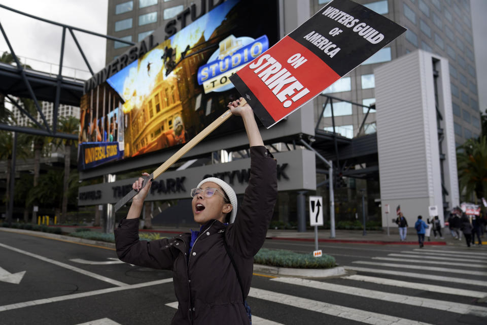 Writer Saroya Wheatley shouts slogans while picketing with fellow members of The Writers Guild of America outside of Universal Studios Thursday, May 4, 2023, in Universal City, Calif. The first Hollywood strike in 15 years commenced Tuesday as the 11,500 members of the Writers Guild of America stopped working when their contract expired. (AP Photo/Marcio Jose Sanchez)
