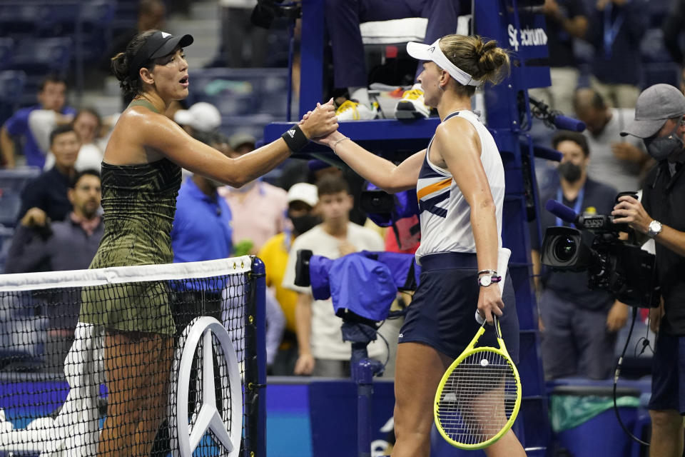 Garbine Muguruza, of Spain, left, shakes hands with Barbora Krejcikova, of the Czech Republic, after Krejcikova won during the fourth round of the US Open tennis championships, Sunday, Sept. 5 2021, in New York. (AP Photo/Frank Franklin II)